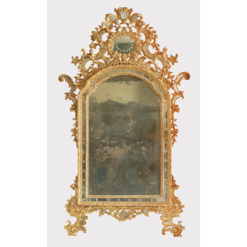 A highly important and unique Italian Rococó carved and giltwood mirror decorated with the original etched glass plates.