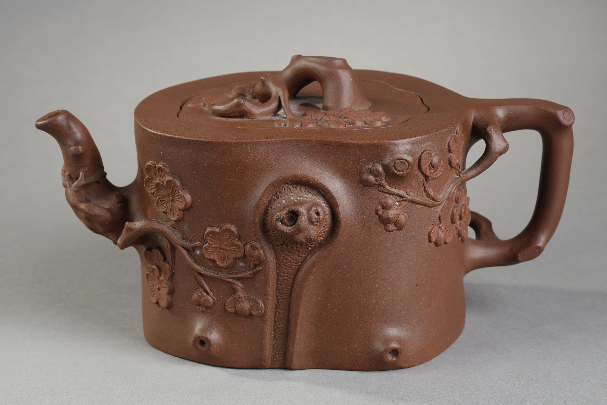 Yixing  ware   pourer (Jiangsu province in eastern China. trunk-shaped and prunus branch in bloom. Seal under the surrounded base surrounded by leiwen thunder patterns. 
and seal of Shao Quanyin  She ji
Seal inside the lid Quanheng (first name of the artisan) China 19th century