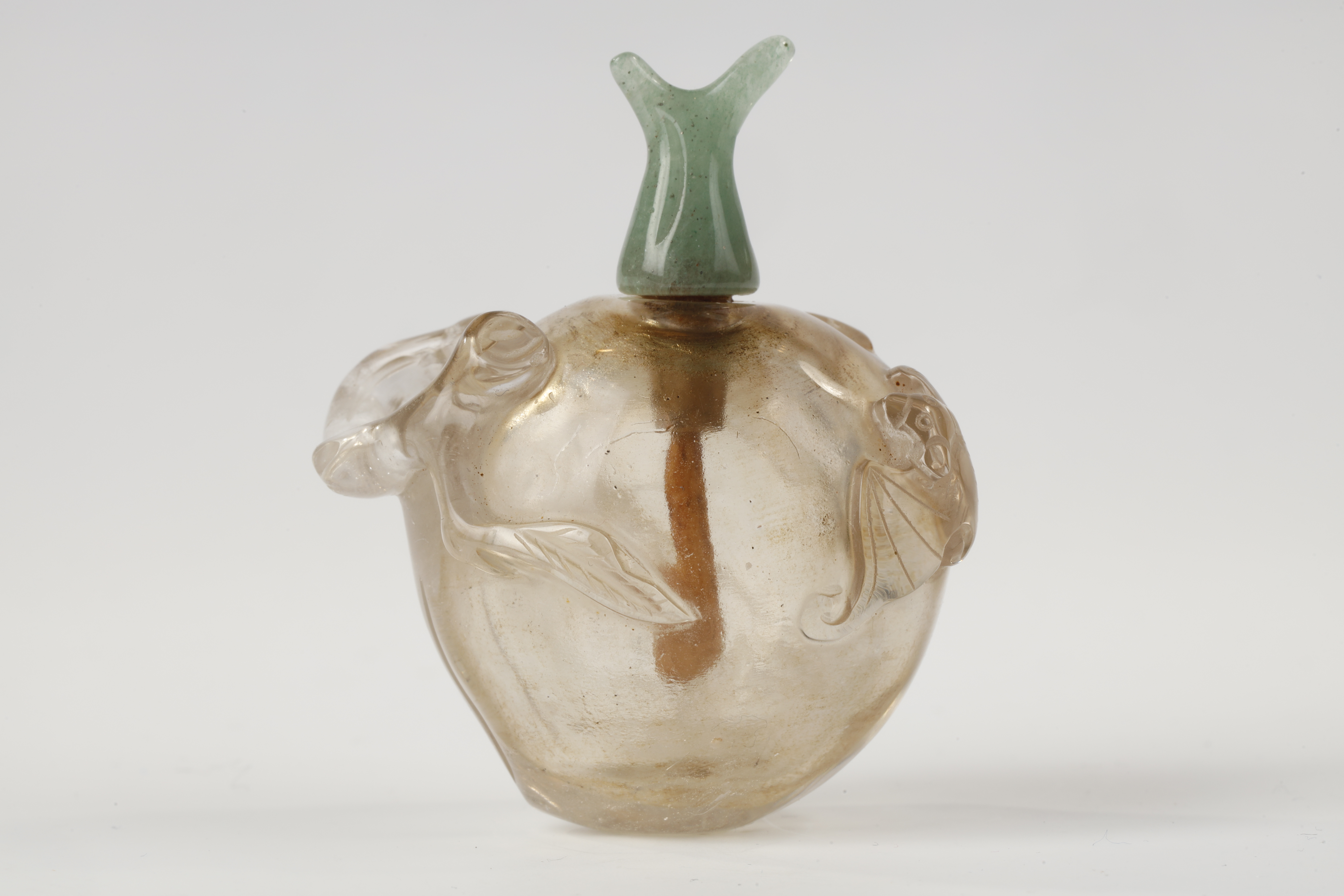 Small rock crystal snuff bottle carved in the shape of a peach (longevity) with a bat China 19th century
