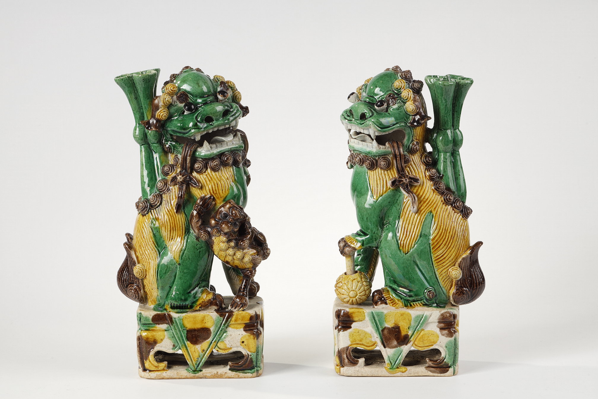 Pair of Fo dogs in enameled biscuit, three colors (green, yellow and eggplant)  
China Period Kangxi 1662/1722