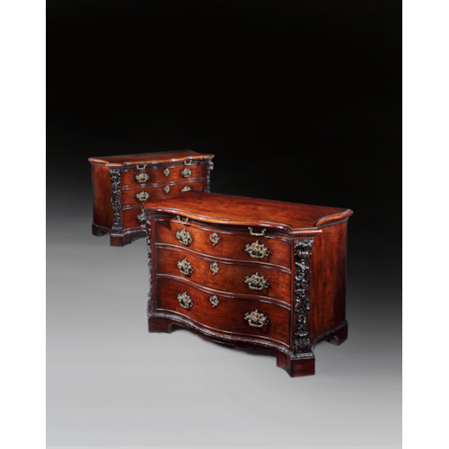 A highly important pair of serpentine fronted mahogany commodes
