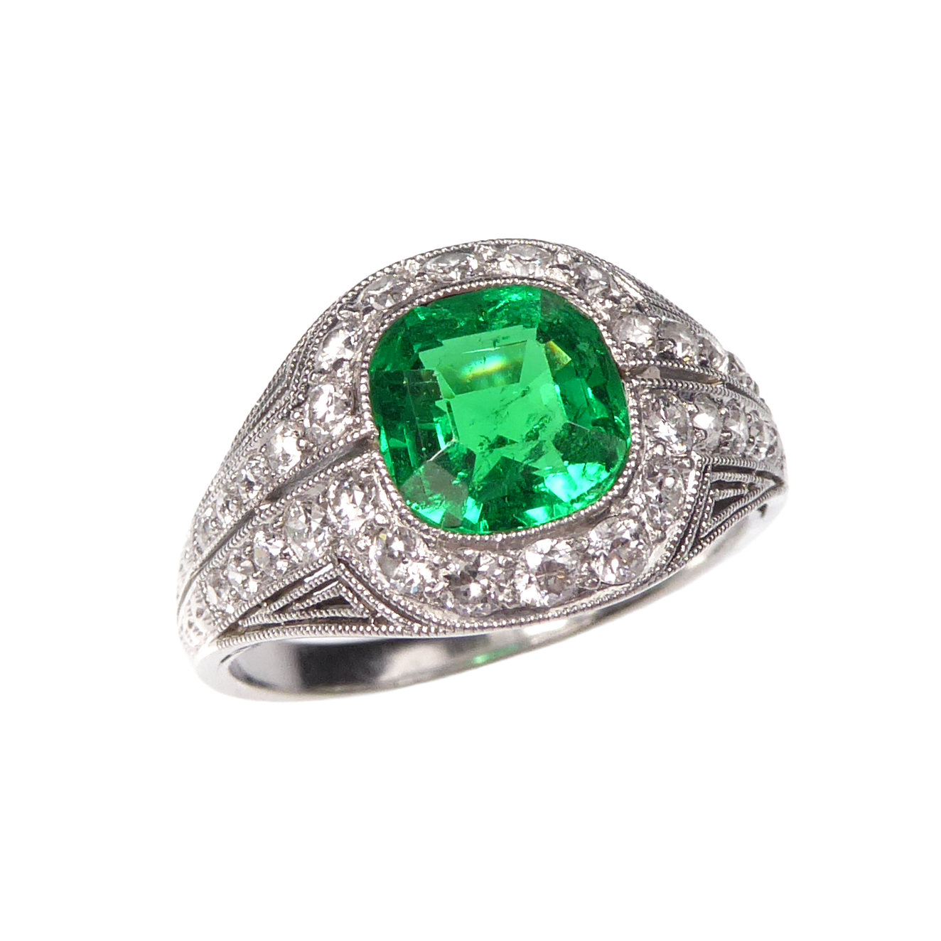 Early 20th century cushion cut emerald and diamond cluster ring by Marcus, American c.1910