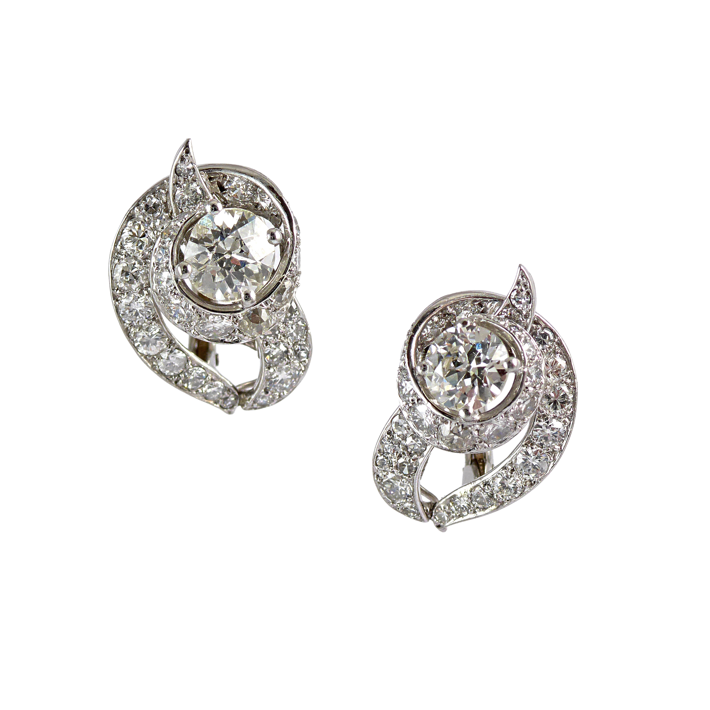 Pair of diamond scroll earrings by Cartier, London, with a looping ...